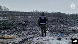 A rescue worker surveys the site of a Russian military plane crash in the Belgorod region on January 24.