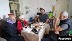 Armenia - Archbishop Bagrat Galstanian (left) meets a woman in Shurnukh village, June 30, 2024.