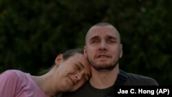 Vlada Rjabec (balra) vőlegénye, Ivan Szoroka vállára hajtja fejét egy rehabilitációs központban, amelyet a harctéren látásukat elvesztő katonák számára alakítottak ki az ukrajnai Rivne közelében