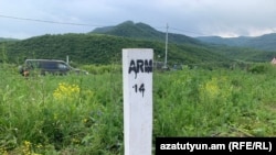 A pillar installed to mark the Armenian-Azerbaijani border at one of the sections near the Armenian village of Kirants during the demarcation process in April-May 2024.