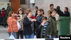 Armenia- Refugees from Nagorno-Karabakh wait upon their arrival at a temporary accommodation centre in the town of Goris, September 25, 2023.