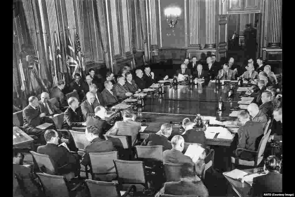 Această imagine prezintă prima reuniune a Consiliului Atlanticului de Nord din septembrie 1949. Cu o lună înainte de această reuniune de la Washington D.C., un tratat semnat de Statele Unite, Canada, Regatul Unit și alte nouă țări europene a intrat în vigoare, anunțând înființarea Organizației Tratatului Atlanticului de Nord. 
