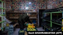 Nagorno-Karabakh - A man holds a fruit in an empty market in Stepanakert, December 23, 2022.