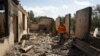 ARMENIA -- Firefighters work among the ruins of a house in the village of Sotk hit by Azerbaijani shelling during border clashes, September 14, 2022.