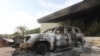 A burned car is seen in front of the U.S. Consulate in Benghazi, Libya, after it was attacked and set on fire by gunmen on September 11, 2012.