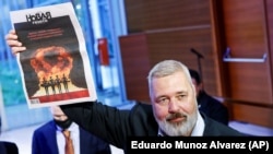 Dmitry Muratov, editor in chief of Novaya gazeta, poses after auctioning off his 2021 Nobel Peace Prize in New York on June 20. He donated the proceeds to raising money for Ukrainian child refugees. 