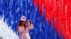 A woman takes a photo of an installation made in the colors of the Russian national flag at a Russia Day celebration in St. Petersburg on June 12.