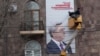 Armenia - Workers put up an election billboard of President Serzh Sarkisian in Yerevan, 21Jan2013.