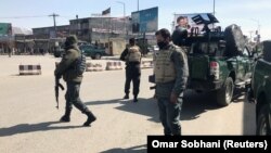 Policemen keep watch near the side of an attack in Kabul on March 7.