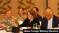 U.S. Special Envoy Zalmay Khalilzad, right, attends a meeting for peace talks in Doha on March 12.