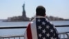 An immigrant looks toward New York's Statue of Liberty during a march for immigration reform in April.