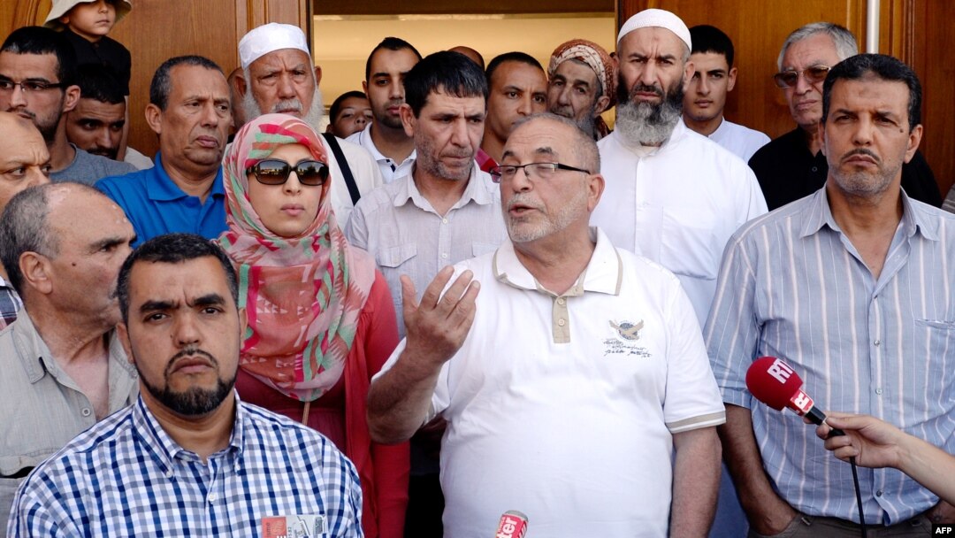 The rector of Lyon's Grand Mosque, Kamel Kabtane (center), has called for government action to counter the fear of Muslims.