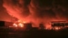 Oil tanks burn at the port in Hodeidah, Yemen, in July. (file photo)