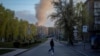 A man crosses a street near the site of a Russian drone attack in Kyiv on April 12. 