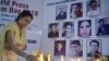 An Indian journalist lights candles during a vigil for Afghan journalists who were killed in a targeted suicide bombing in April, including two reporters who worked for RFE/RL's Radio Free Aghanistan, as well as a female trainee.