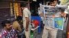 An auto-rickshaw driver reads a newspaper with front-page reports on the Indian air strikes against purported militant camps in Pakistan's territory, in Mumbai, on February 27.
