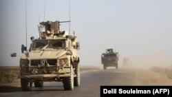 SYRIA -- U.S. armored vehicles patrol in the countryside of the eastern Syrian Deir Ezzor province, January 31, 2019