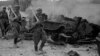 Battle of Ihantala. Finnish soldiers, armed with German Faust cartridges, pass by a destroyed Soviet tank, 1944