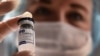 RUSSIA -- A medical worker holds a vial with Russia's Sputnik V (Gam-COVID-Vac) vaccine against the coronavirus disease at a vaccination point at the GUM department store in Moscow, January 18, 2021