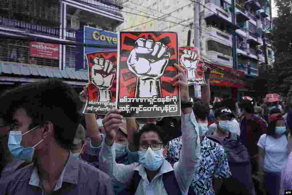 Protestuesit mbajnë parulla kundër ushtrisë gjatë një proteste kundër grushtit të shtetit në Yangon, më 8 shkurt, 2021. (Foto nga STR / AFP)
