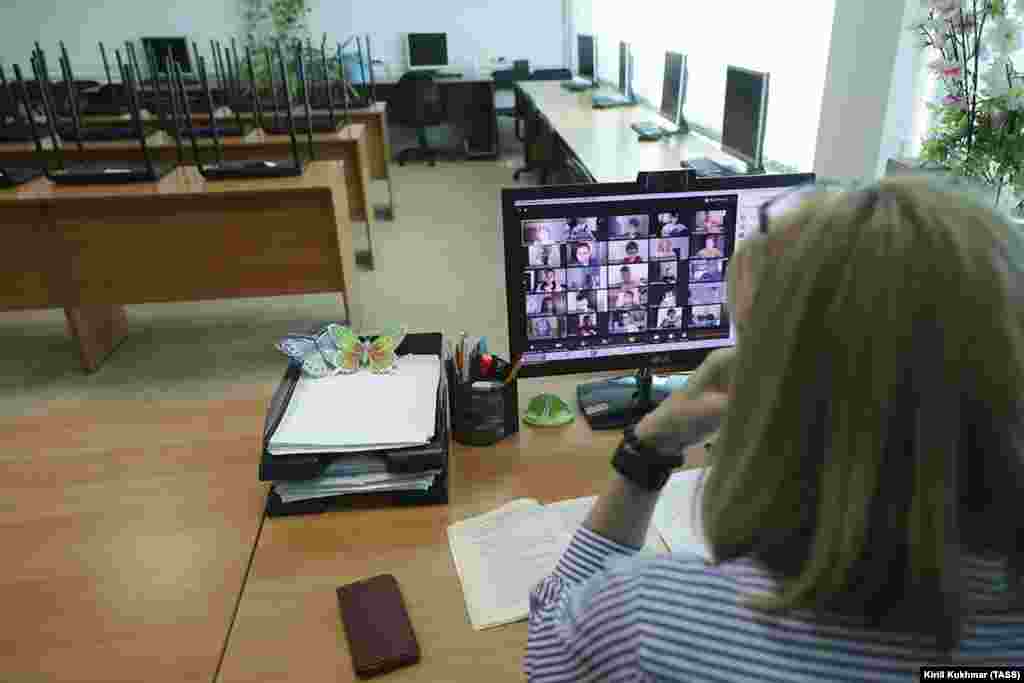 Учитель разговаривает с учащимися с помощью приложения для видеоконференций в Новосибирске (Россия).