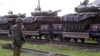 Georgia -- A Russian soldier patrols a military train loaded with tanks of 62nd base in Akhalkalaki at the railroad station of Tsalka some 120 km outside Tbilisi, 15 May 2006