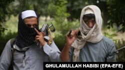 Former Taliban militants are shown turning over their weapons during a reconciliation ceremony in Jalalabad, Afghanistan, on September 3.