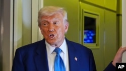 US President Donald Trump speaking to journalists on the board of Air Force One as he concludes his four-day trip to the Middle East.