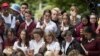 Students hold candles during a moment of silence on March 18 at a vigil to commemorate victims of the March 15 shooting in Christchurch.