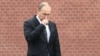 Russia -- Russian President Vladimir Putin stands under pouring rain during a ceremony marking the 76th anniversary of the Nazi German invasion, by the Kremlin walls in Moscow, June 22, 2017