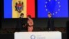 Moldovan Prime Minister Iurie Leanca (left) shakes hands with EU foreign policy chief Catherine Ashton as European Commissioner for Trade Karel de Gucht looks on after Leanca initialed Moldova's Association Agreement with the EU.