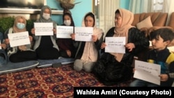 Women protest inside a private home on October 30. The protests are part of a campaign by women activists to press the Taliban for their right to work, get an education, and participate in public life.