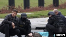 A gunman identified as Mevlik Jasarevic lies on the street after being overwhelmed after he fired shots at the U.S. Embassy in Sarajevo on October 28.